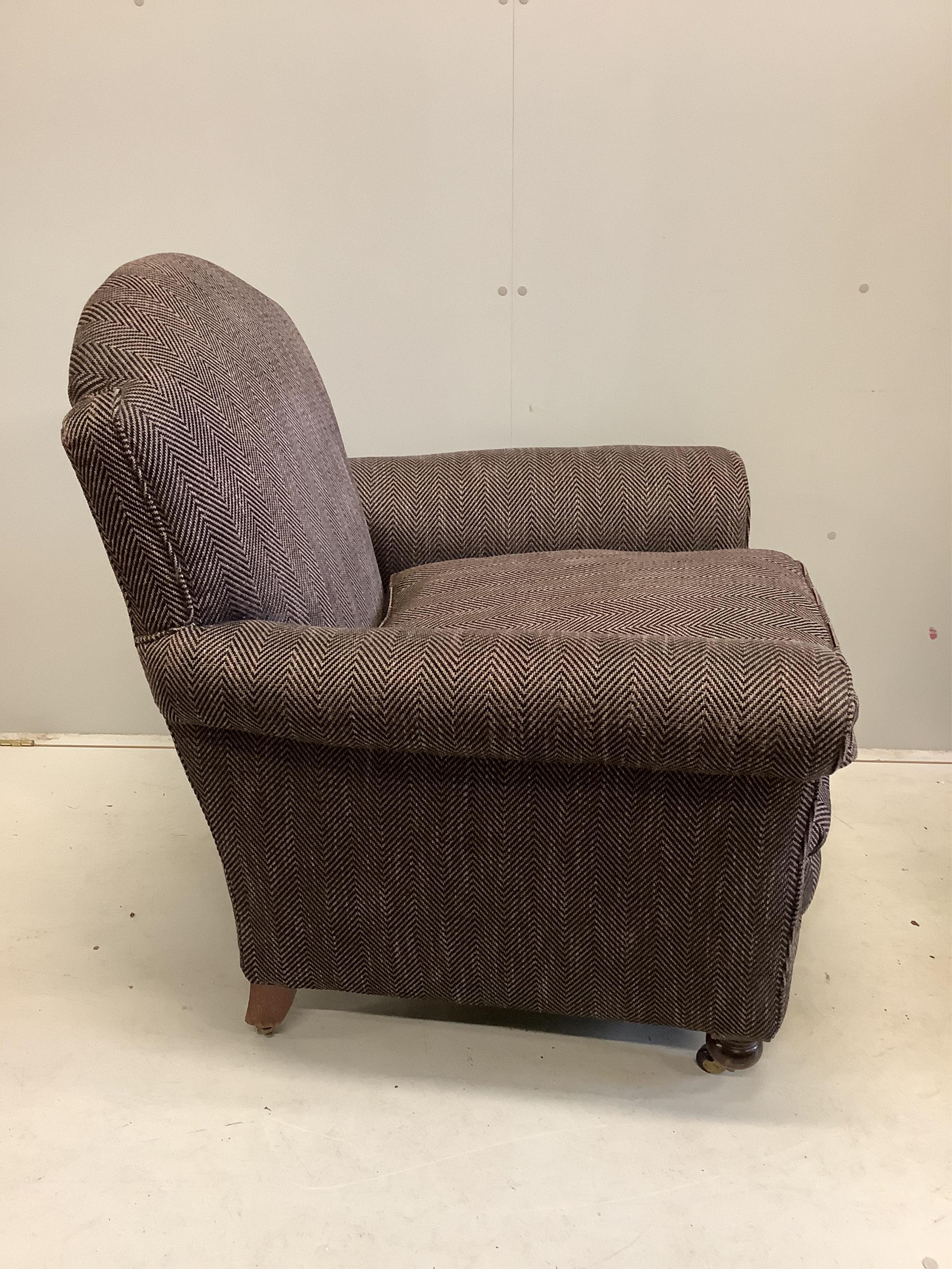 A near pair of early 20th century upholstered armchairs, recently upholstered, larger width 92cm, depth 90cm, height 98cm, together with a spare roll of upholstery fabric. Condition - good